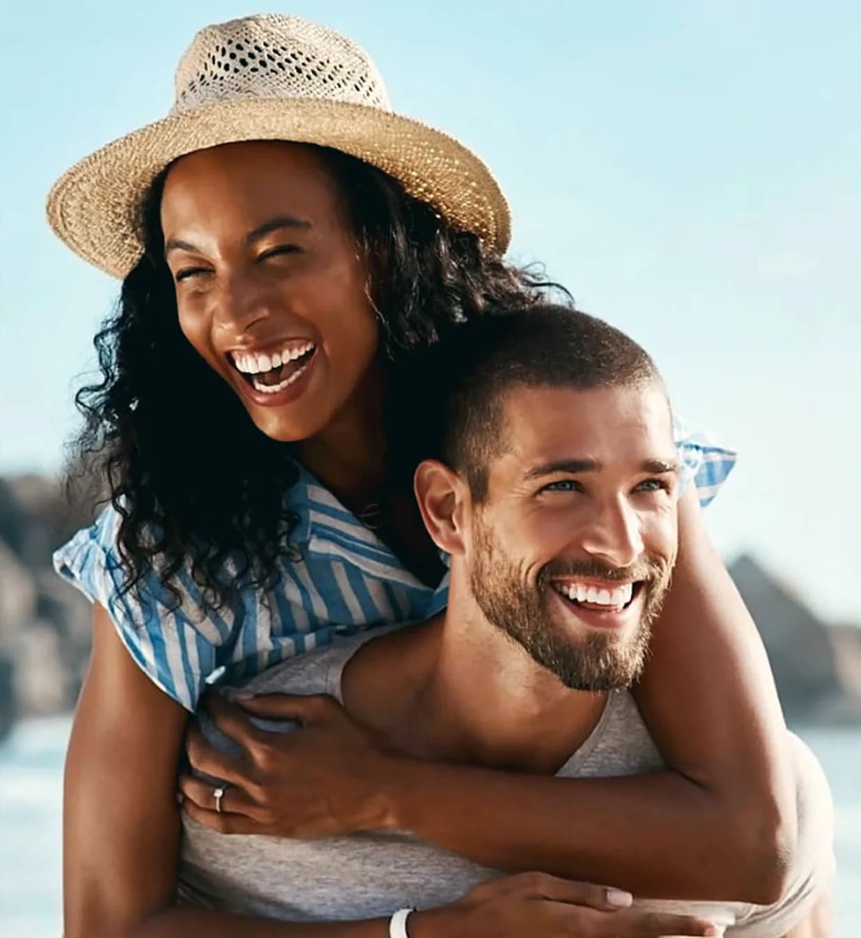 A young couple laughing on the beach